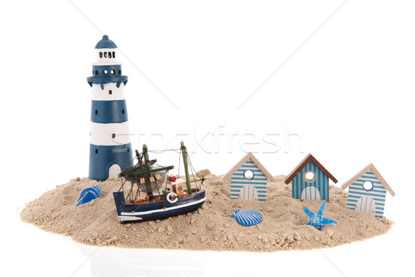 Beach huts and lighthouse at the coast Stock photo © ivonnewierink
