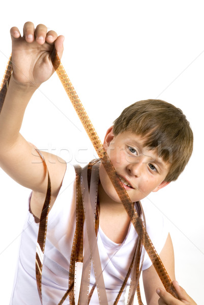 Stock photo: Young boy with celluloid movie
