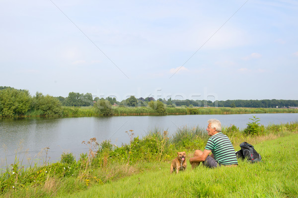 Man with dog near the river Stock photo © ivonnewierink