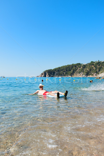 Stock photo: Retired man playing in sea water