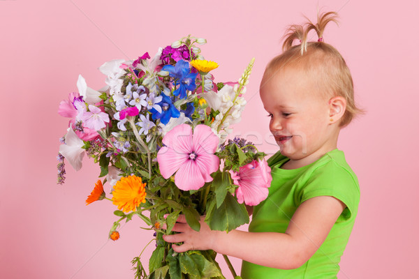 Toddler girl with flowers Stock photo © ivonnewierink
