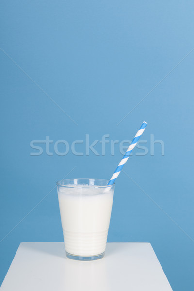 Glas of milk on blue Stock photo © ivonnewierink