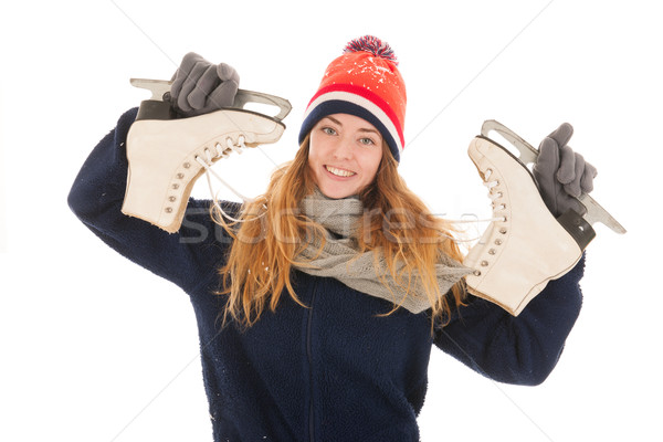 Attractive woman is having fun with ice skates Stock photo © ivonnewierink