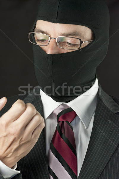  Businessman Wearing Balaclava Checks Nails Stock photo © jackethead