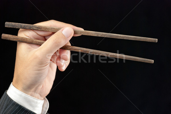 üzletember tart evőpálcikák közelkép kéz étel Stock fotó © jackethead
