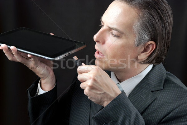 Businessman Plugs In Tablet Stock photo © jackethead