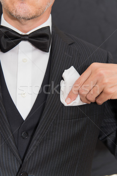 Gentleman In Black Tie Fixes Pocket Square, Vertical Stock photo © jackethead