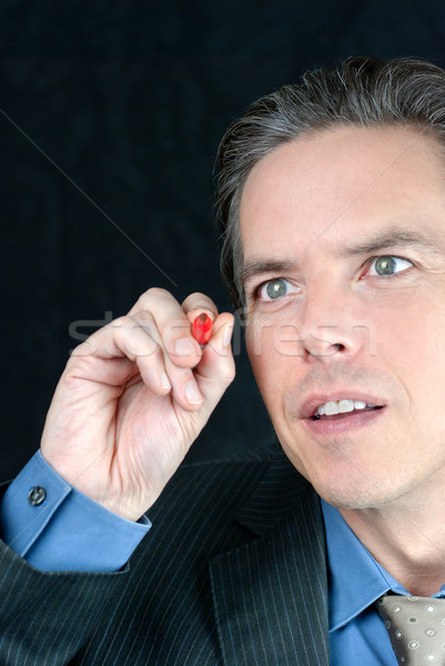 Intense Businessman Writes On Fourth Wall Stock photo © jackethead