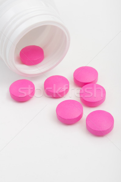 Rosa pastillas blanco botella medicina plástico Foto stock © jamdesign