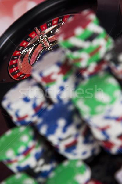 Poker Chips on a gaming with casino roulette Stock photo © JanPietruszka