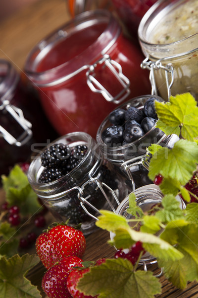 Glass of mixed berry jam with strawberries, bilberries, red curr Stock photo © JanPietruszka