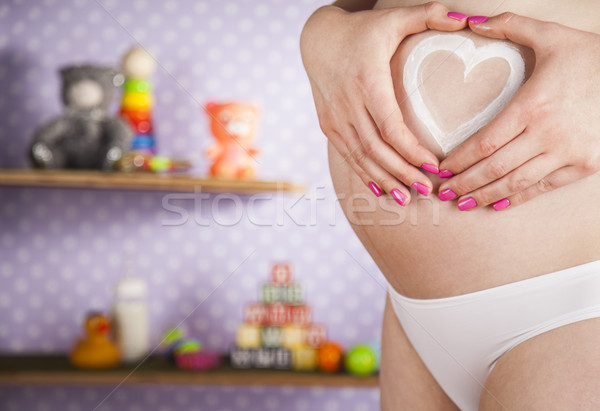 Pregnant woman holding a heart Stock photo © JanPietruszka