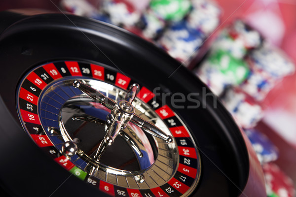 Poker Chips on a gaming with casino roulette Stock photo © JanPietruszka