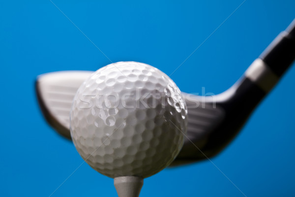 Golf ball on green grass over a blue background  Stock photo © JanPietruszka