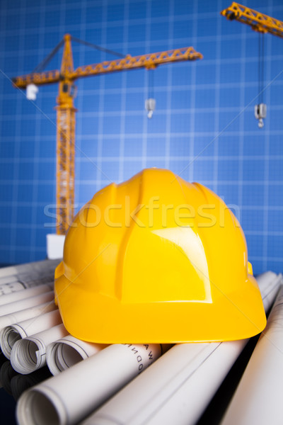 Stock photo: Construction plan with a crane and yellow helmet