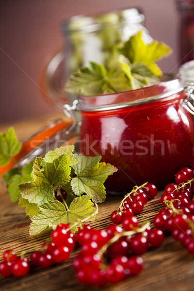 Jams in glass jars with wood and fresh berries  Stock photo © JanPietruszka