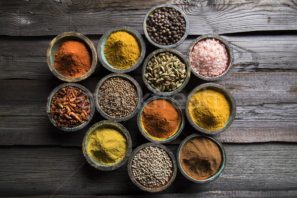 A selection of various colorful spices on a wooden table in bowl Stock photo © JanPietruszka