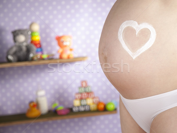 Stock photo: Pregnant woman loving heart her baby