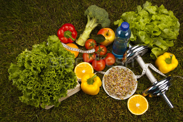Vitamin and Fitness diet, dumbell in green grass Stock photo © JanPietruszka