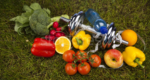 Vitamin and Fitness diet, dumbell in green grass  Stock photo © JanPietruszka