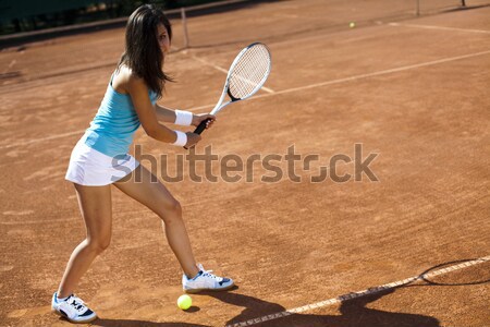 Stock photo: Girl playing tennis on the court