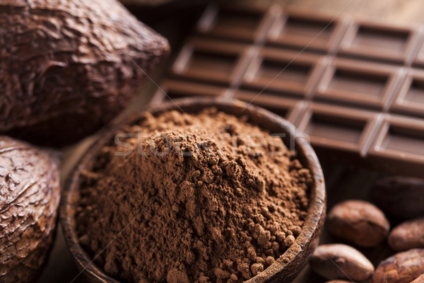 Chocolate bar, candy sweet, cacao beans and powder on wooden bac Stock photo © JanPietruszka