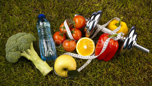 Vitamin and Fitness diet, dumbell in green grass  Stock photo © JanPietruszka