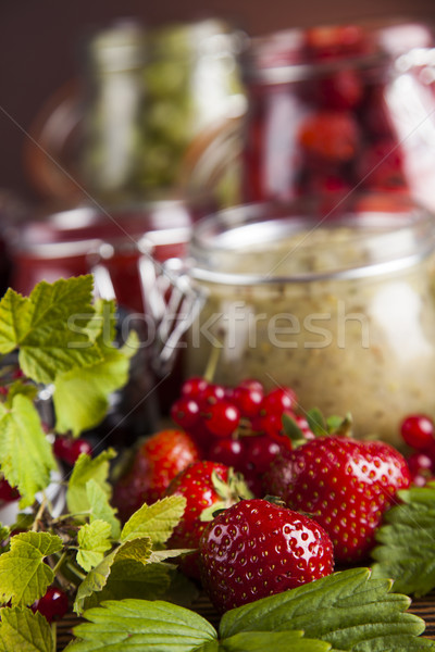 Jams in glass jars with wood and fresh berries  Stock photo © JanPietruszka