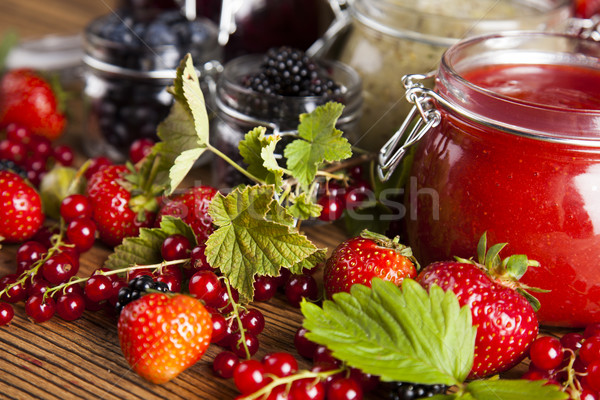 Jams in glass jars with wood and fresh berries  Stock photo © JanPietruszka