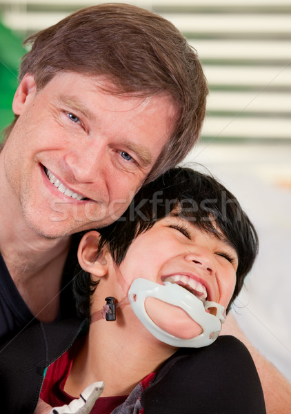 Smiling father holding disabled son Stock photo © jarenwicklund