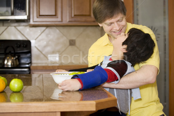 Father helping disabled son with work in the kitchen Stock photo © jarenwicklund