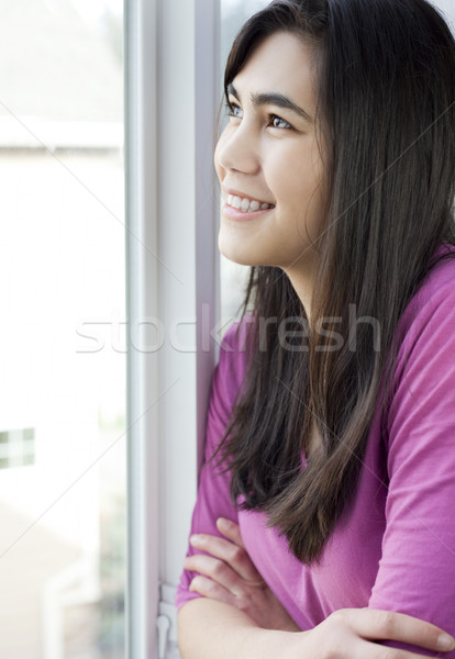 Side profile of teen girl or young woman looking out window Stock photo © jarenwicklund