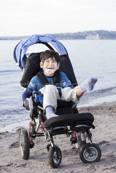 Felice disabili ragazzo sedia a rotelle spiaggia cinque anni Foto d'archivio © jarenwicklund