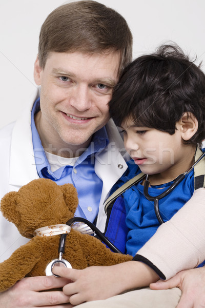 Male doctor interacting with disabled  toddler patient on lap Stock photo © jarenwicklund
