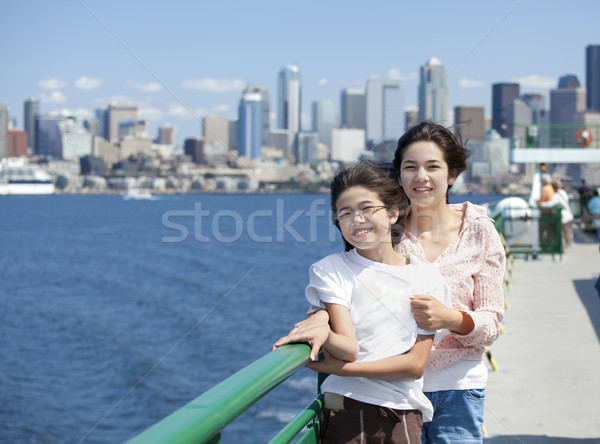 Two sisters on ferry deck with Seattle skyline in background Stock photo © jarenwicklund