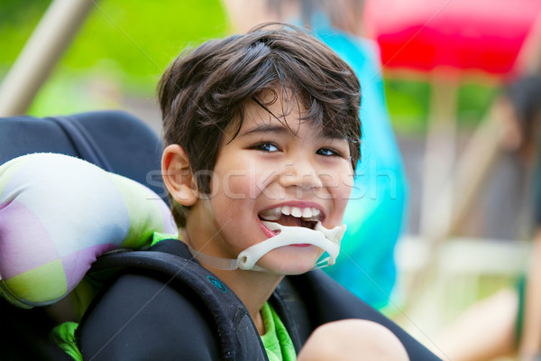 Niepełnosprawnych ośmioletni chłopca wózek uśmiechnięty przystojny Zdjęcia stock © jarenwicklund
