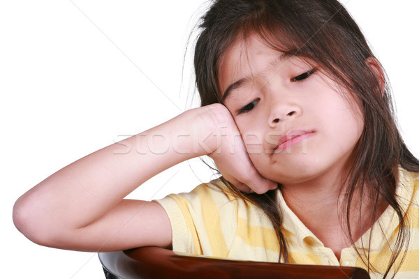 Sad nine year old girl sitting on chair, bored. Stock photo © jarenwicklund