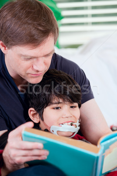 Father reading book to disabled little son Stock photo © jarenwicklund