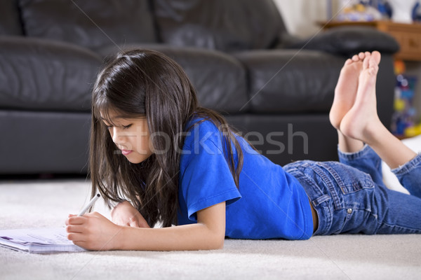 Little girl doing her homework on floor Stock photo © jarenwicklund