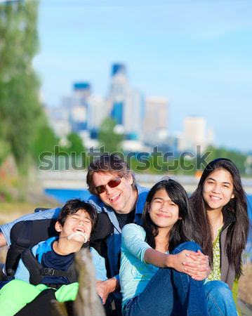 Father and mother with children at park, surrounding disabled so Stock photo © jarenwicklund