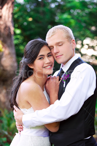 Caucasian groom holding his biracial bride, smiling. Diverse cou Stock photo © jarenwicklund