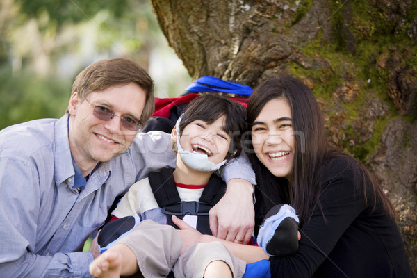 Disabled boy in wheelcahir surrounded by father and sister Stock photo © jarenwicklund