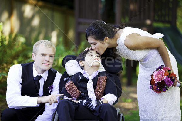 Biracial bride kissing her little brother on her wedding day. Ch Stock photo © jarenwicklund