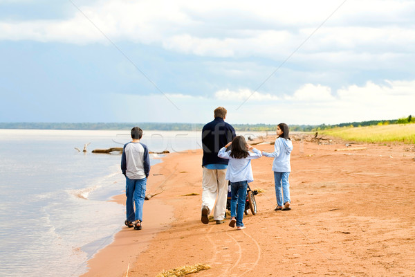 Father and children strolling along the deserted lake shore on s Stock photo © jarenwicklund