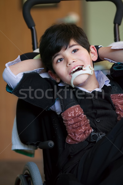 Jóképű mozgássérült nyolcéves fiú mosolyog megnyugtató Stock fotó © jarenwicklund