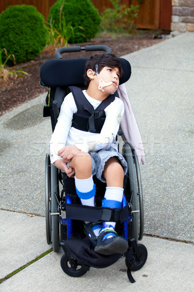 Seven year old biracial disabled boy in wheelchair Stock photo © jarenwicklund