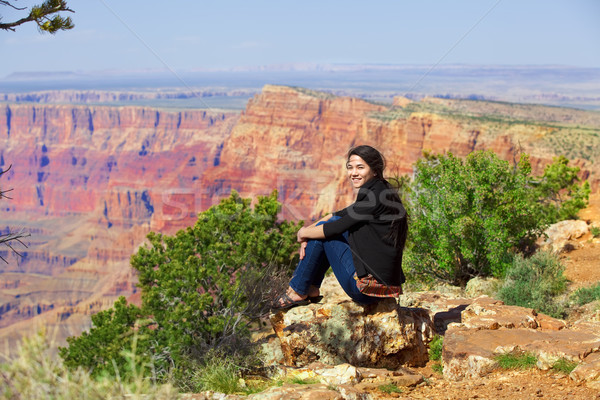 Biracial teen girl sitting along rock ledge at Grand Canyon Stock photo © jarenwicklund