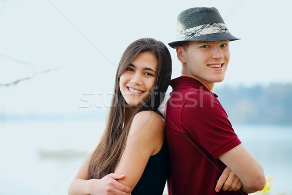 Beautiful young interracial couple standing back to back Stock photo © jarenwicklund