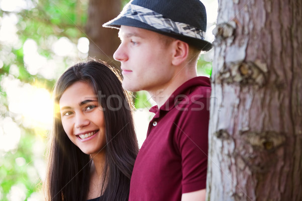 Young couple standing among trees, sunlight streaming Stock photo © jarenwicklund