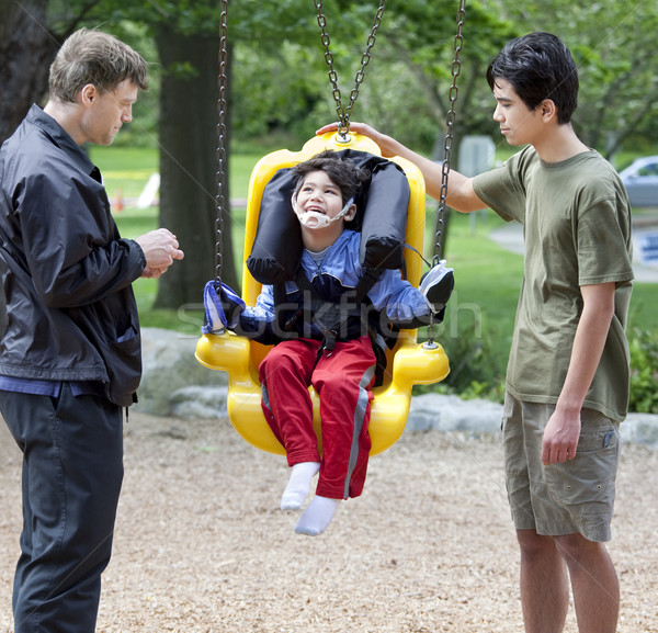 Mozgássérült kicsi fiú fogyatékos hinta család Stock fotó © jarenwicklund